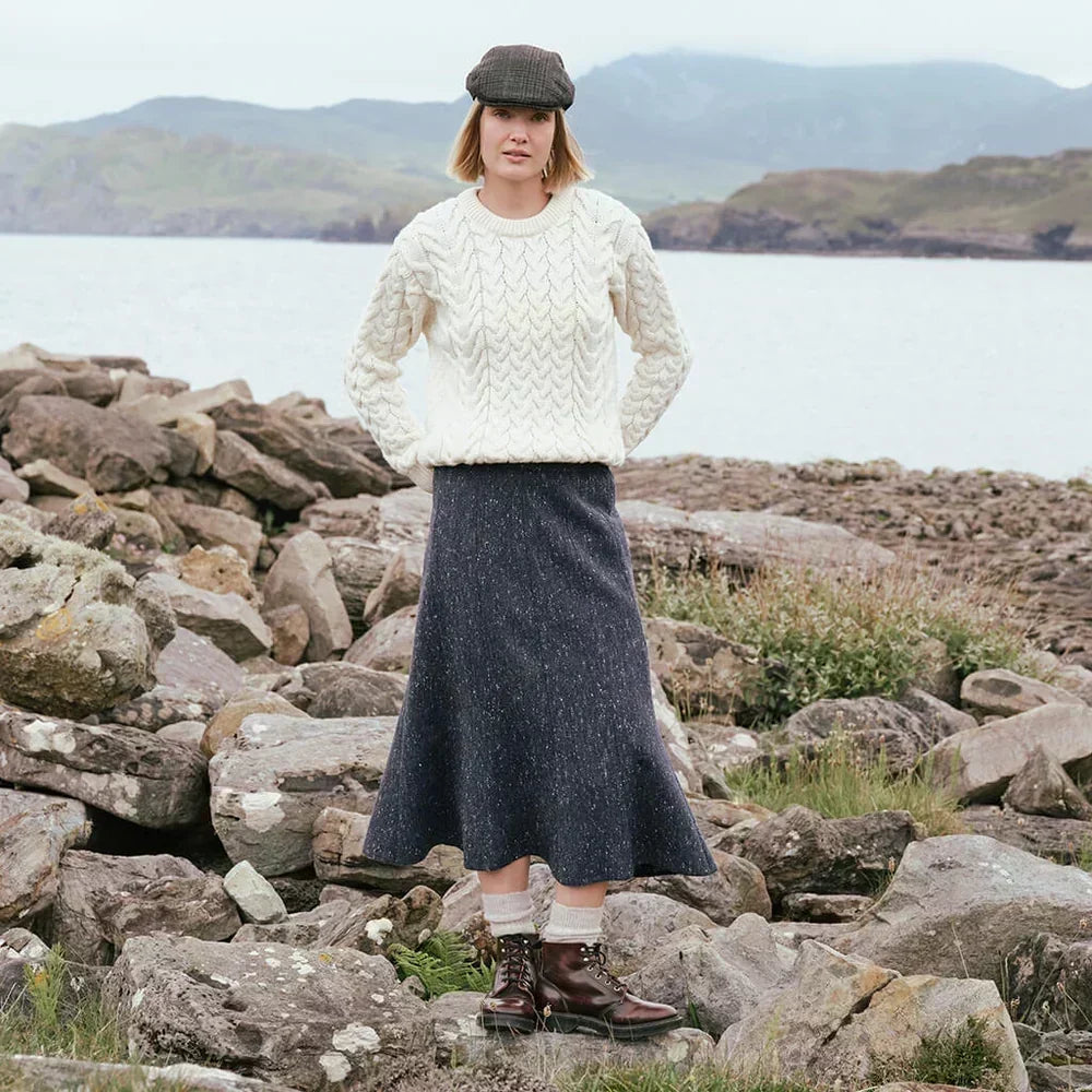 Image featuring the Irish Tweed Fleck A-Line Skirt in navy, crafted from authentic Irish flecked tweed with a flattering A-line shape, showcasing timeless Irish heritage style in a rugged coastal setting.