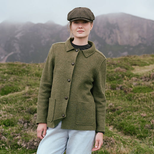 Image featuring the Women's Irish Tweed Overshirt Jacket in olive green, crafted from authentic Irish tweed with a timeless button-front design, tailored collar, and practical patch pockets, showcased in a scenic countryside setting inspired by Ireland's natural beauty.