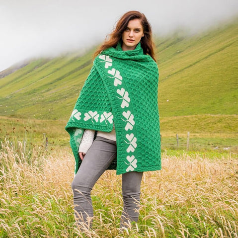 Irish woman wrapped on a green Shamrock Merino Wool Blanket on a mountainous background