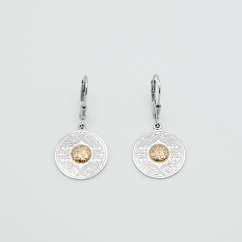 Pair of silver earrings with gold accents on a light gray background