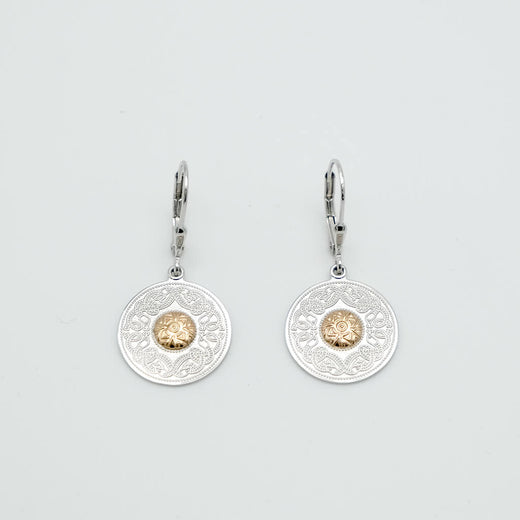 Pair of silver earrings with gold accents on a light gray background