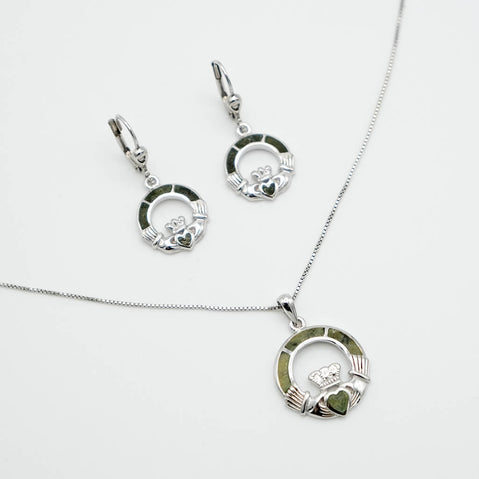 Silver Claddagh necklace and earring set on a white background