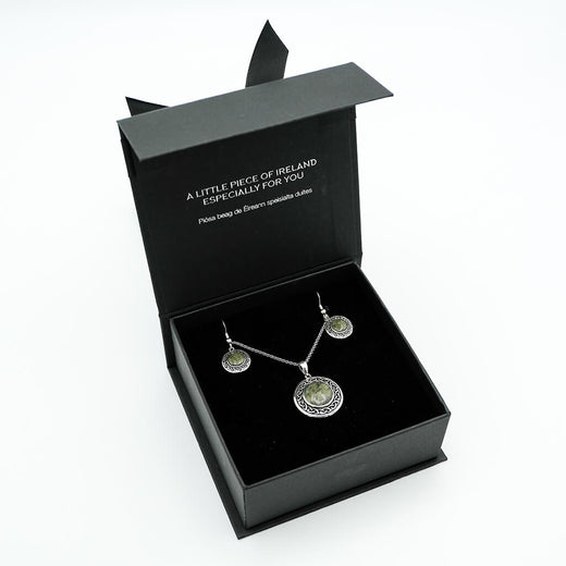Jewelry set in a black box with text on a white background