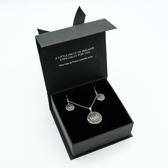 Jewelry set in a black box with text on a white background