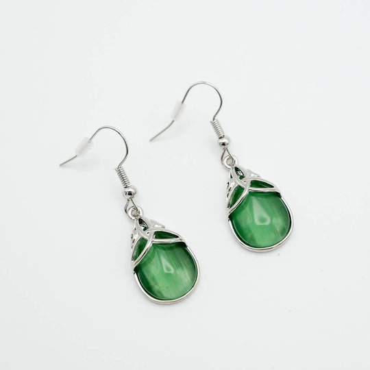 Green teardrop earrings with silver hooks on a white background