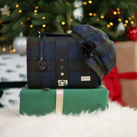 Fiona Tweed bag and hat on a green gift box with Christmas tree and presents in the background
