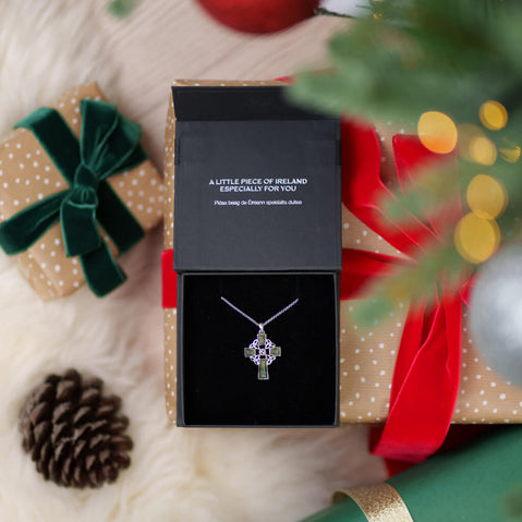 Jewelry box with a Marcasite & Connemara Marble Celtic Cross, surrounded by festive decorations.