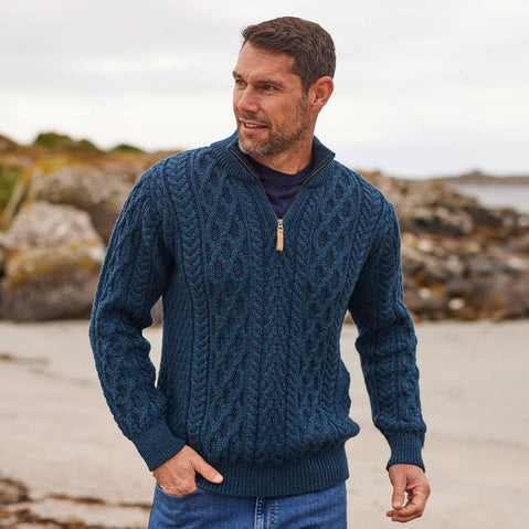 Man wearing a blue knitted sweater on a beach