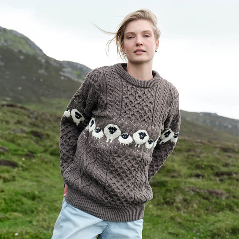 Image featuring the Traditional Sheep Aran Sweater in brown, crafted with authentic Irish Aran knit patterns and iconic sheep motifs, combining heritage-inspired Irish knitwear with timeless countryside style and traditional craftsmanship.