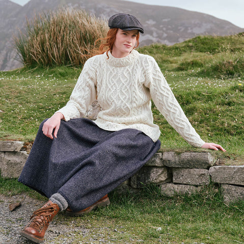 Image featuring the Women's Cable Knit Aran Tunic Sweater in natural cream, crafted with authentic Irish Aran cable knit patterns and a flattering tunic design, inspired by Ireland's rich knitting heritage and rugged countryside.