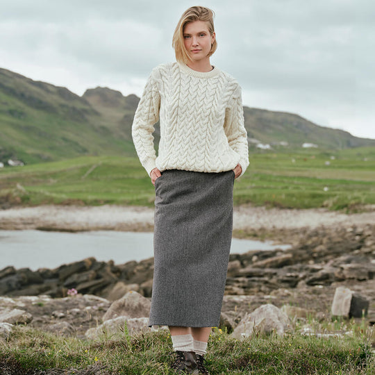Image featuring the Irish Tweed Herringbone A-Line Skirt in gray, crafted from authentic Irish tweed with a timeless herringbone pattern and flattering A-line shape, showcasing classic Irish heritage style against a rugged countryside backdrop.