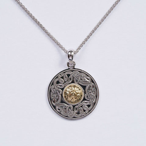 A silver Celtic warrior pendant with a gold bead, featuring intricate knot designs, attached to a silver chain.