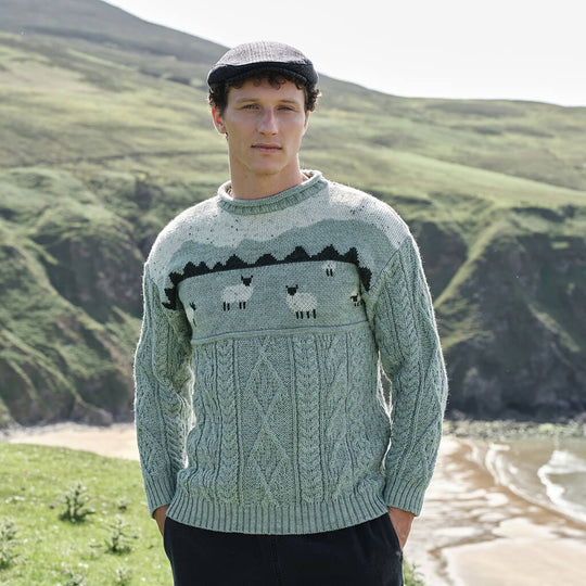 Image featuring the Sheep Aran Sweater in green, crafted with authentic Irish Aran cable knit patterns and traditional sheep motifs, combining heritage-inspired Irish knitwear with timeless countryside style and classic Aran craftsmanship.