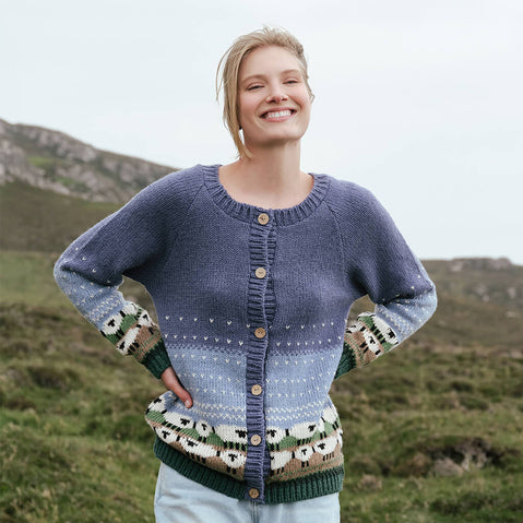 Image featuring the Women's Button Front Hand Knit Sheep Cardigan, crafted with hand-knit textures, heritage-inspired sheep motifs, and classic button-front styling, showcasing traditional Irish craftsmanship in a rugged countryside setting.
