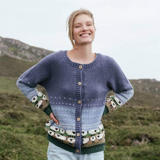 Image featuring the Women's Button Front Hand Knit Sheep Cardigan, crafted with hand-knit textures, heritage-inspired sheep motifs, and classic button-front styling, showcasing traditional Irish craftsmanship in a rugged countryside setting.