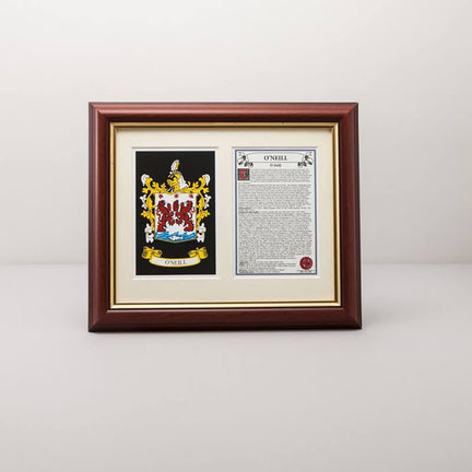 Framed personalized family crest display featuring a colorful coat of arms and an accompanying printed history, set in a dark wood frame on a mantel.