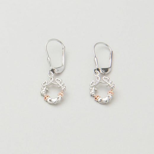 A pair of silver earrings featuring a looped heart design with a lucky shamrock and the iconic Irish Claddagh symbol, accented with a hint of rose gold.