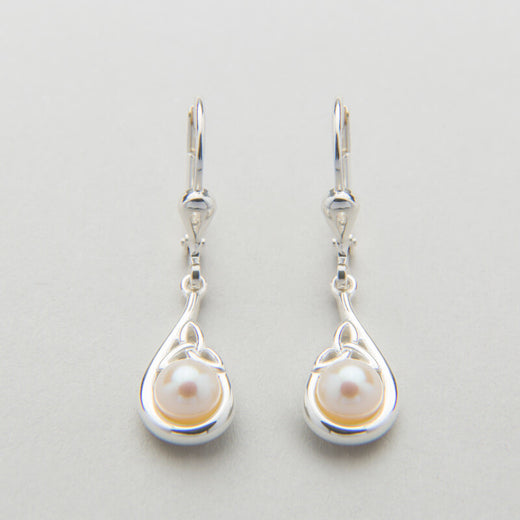 A sterling silver Trinity Knot pendant necklace accompanied by a pair of matching earrings, each featuring a central white pearl, displayed against a light background.
