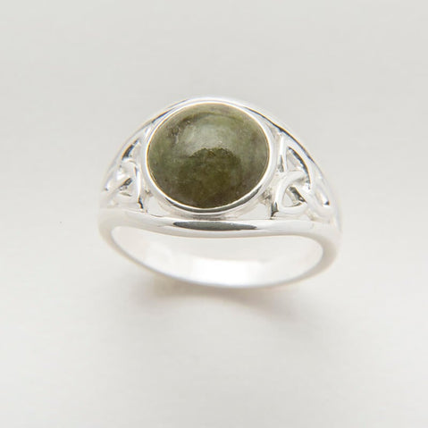 A sterling silver ring featuring a central Connemara marble stone with Celtic knot work on either side.
