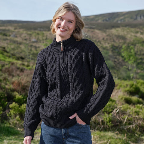 Woman wearing a black Aran sweater in a natural setting