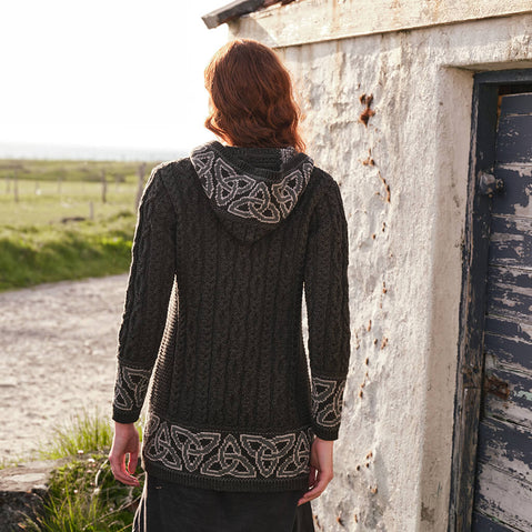 Image featuring the Women's Celtic Knot Hooded Aran Coat in army green, crafted with authentic Irish cable knit patterns and intricate Celtic knot accents, blending timeless Aran craftsmanship with traditional Celtic design.