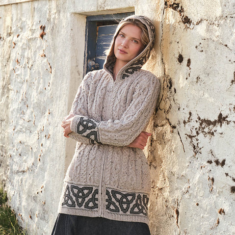 Image featuring the Women's Celtic Knot Hooded Aran Sweater Cardigan in oatmeal, crafted with authentic Irish Aran cable knit patterns, signature Celtic knot accents, a cozy hood, and full-zip closure, showcasing timeless Irish craftsmanship and heritage-inspired design.