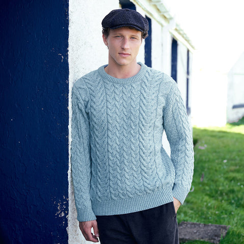 Image featuring the Men's Cable Knit Crew Neck Sweater in mermaid, crafted with authentic Irish cable knit patterns and a timeless crew neck silhouette, showcasing traditional Aran craftsmanship inspired by Ireland's coastal heritage.