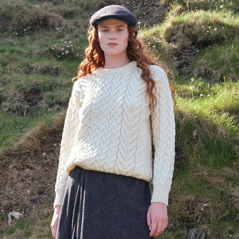 Image featuring the Women's Cable Knit Crew Neck Sweater in natural cream, crafted with authentic Irish cable knit patterns and a timeless crew neck silhouette, inspired by Ireland's rich knitting heritage.