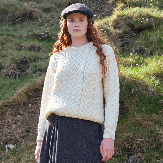 Image featuring the Women's Cable Knit Crew Neck Sweater in natural cream, crafted with authentic Irish cable knit patterns and a timeless crew neck silhouette, inspired by Ireland's rich knitting heritage.