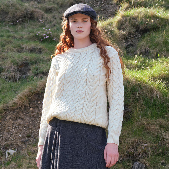 Image featuring the Women's Cable Knit Crew Neck Sweater in natural cream, crafted with authentic Irish cable knit patterns and a timeless crew neck silhouette, inspired by Ireland's rich knitting heritage.
