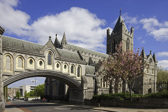 Christchurch, Dublin. A historic church with gothic architecture, featuring arched windows and a prominent tower, set against a blue sky with scattered clouds.