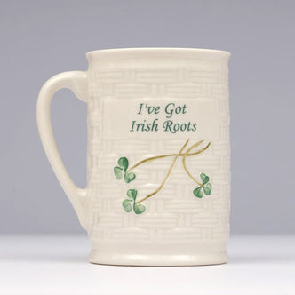 Cream Belleek mug featuring a woven‑style texture with green shamrocks and the text “I’ve Got Irish Roots” on the front.