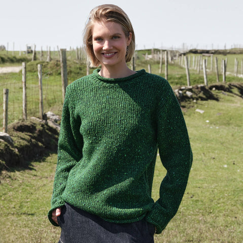 Women's Traditional Fisherman Irish Wool Sweater in Valley Green, crafted from premium Irish wool with authentic fisherman knit texture, styled in the Irish countryside with rolling green fields and traditional rural scenery.