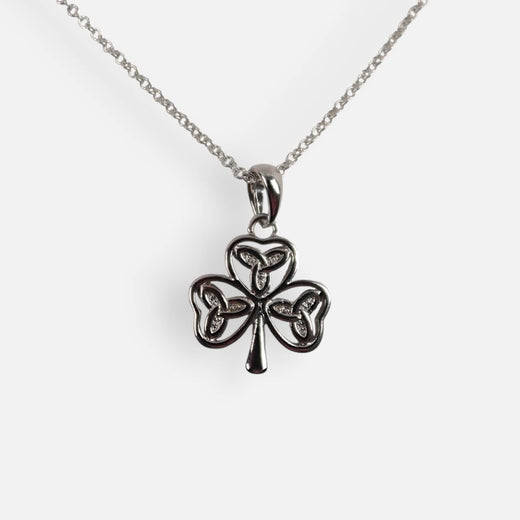 Silver shamrock pendant necklace on a white background