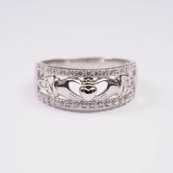 A sterling silver ring featuring the Trinity Knot and Claddagh designs.