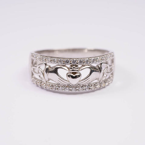 A sterling silver ring featuring the Trinity Knot and Claddagh designs.