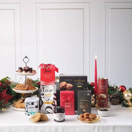 Christmas Family Delights Hamper with rich fruit cake, Irish cookies, gourmet fudge, preserves, tea, and festive treats beautifully arranged for the holiday season – available at GiftsDirect.com