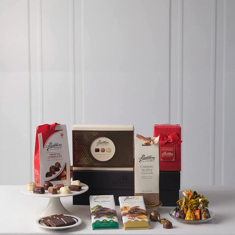 Butlers chocolate products including boxes, bags, and truffles on a white surface with a light gray background.
