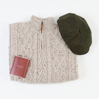 Beige cable knit zip-up sweater with wooden zipper pull, displayed with Men's Classic Irish Tweed Driving Cap in olive green and burgundy Newgrange Hip Flask Set