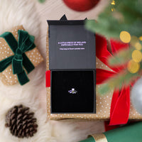 Silver connemara marble ring in a box with a Christmas-themed background