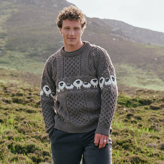 Image featuring the Traditional Sheep Aran Sweater in brown, crafted with authentic Irish Aran knit patterns and iconic sheep motifs, combining heritage-inspired Irish knitwear with timeless countryside style.