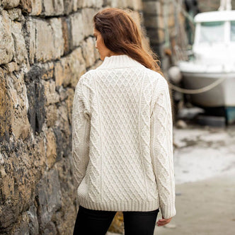 Back view of the women's cream Aran fisherman sweater with diamond stitch pattern and button-mock neck, handcrafted in Ireland from merino wool
