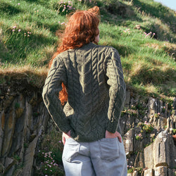 Image featuring the Women's V-Neck Cable Knit Aran Sweater in green, crafted with authentic Irish Aran cable knit patterns and a timeless V-neck silhouette, inspired by Ireland's rich knitting heritage.
