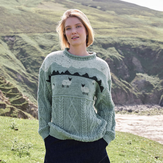 Image featuring the Sheep Aran Sweater in green, crafted with authentic Irish Aran cable knit patterns and traditional sheep motifs, combining heritage-inspired Irish knitwear with timeless countryside style.