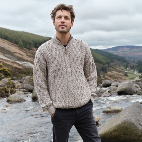Our Men's Half Zip Aran Sweater, crafted from 100% pure new wool, pictured here in the heart of the Irish landscape.