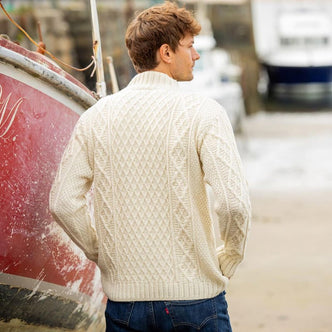 Close-up detail of cream-colored classic fisherman button-mock sweater showing intricate Aran cable knit texture and traditional Irish craftsmanship
