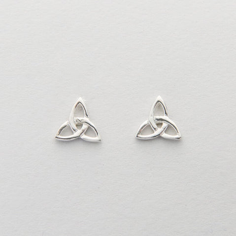 A pair of silver Celtic trinity knot earrings on a white background.