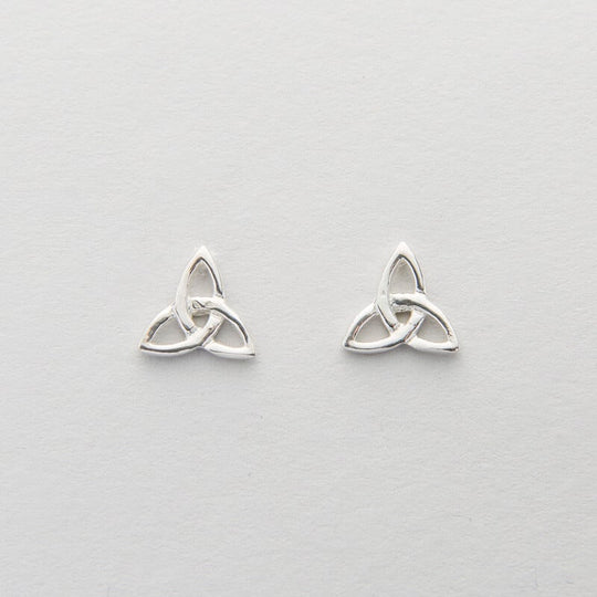 A pair of silver Celtic trinity knot earrings on a white background.