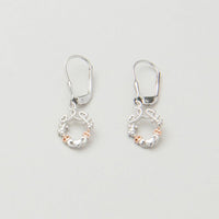 A pair of silver earrings featuring a looped heart design with a lucky shamrock and the iconic Irish Claddagh symbol, accented with a hint of rose gold.