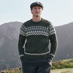 Men's Fair Isle Cable Knit Sweater in army green, crafted with authentic cable knit textures and traditional Fair Isle motifs, combining classic Irish-inspired knitwear with timeless outdoor style in a scenic countryside setting.